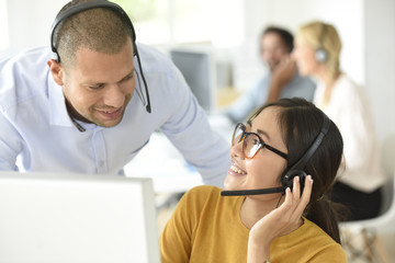Smiling customer office assistant with manager in office