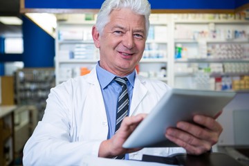 Naklejka na ściany i meble Pharmacist using a digital tablet