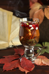 Autumn hot tea with lemon, spices in glass cup
