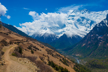 Fototapeta premium Landscape Snow Mountains Nature Viewpoint.Mountain Trekking Landscapes Background. Nobody photo.Asia Travel Sport.Horizontal picture. Sunlights White Clouds Blue Sky. Himalayas Rocks.