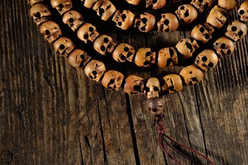 religious rosary of skulls of sandalwood on an old table, closeup

