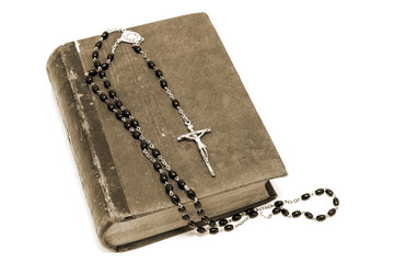 Ancient book and rosary Catholic (prayer beads)