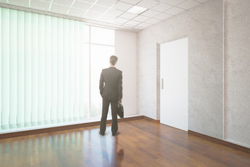 Fototapeta premium Businessman in unfurnished interior
