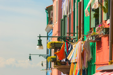 Exterior of colorful houses of Burano Island in Venice.Windows,walls,laundries,flowers and even umbrellas reflects the culture of the people in the island. 
