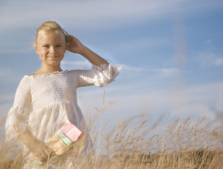 portrait of a little pretty girl in the wheat field