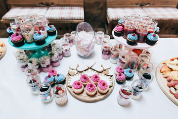 Cakes with raspberries and strawberry jam. Dessert table for a wedding party. 