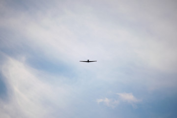 Zlin Z-526F acrobatic airplane flying on cloudy sky