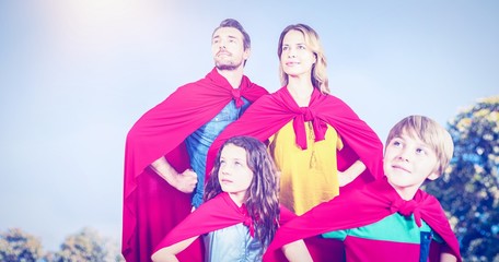 Composite image of family pretending to be superhero 