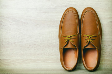 Fototapeta premium Brown Leather shoe on wood table background