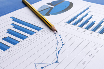 office desk with charts , histograms and financial documents