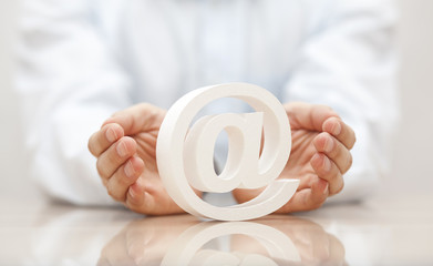 Email symbol protected by hands
