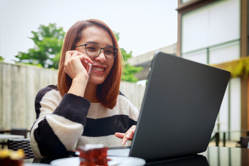 Young asian women smiling happy using laptop and smartphone connected social online, lifestyle technology