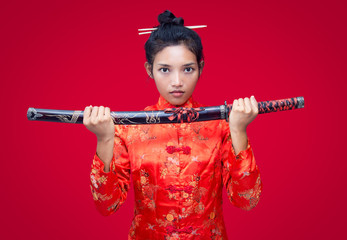 Asian woman holding a sword