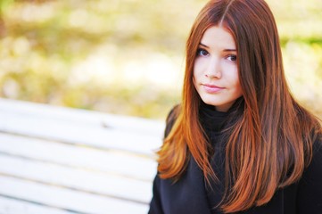 Obraz premium Portrait of a cute brown-eyed girl with her bright hair on sun