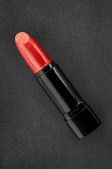 Red lipstick tube on gray background. Clipping path included