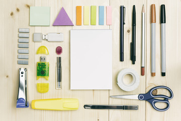 Office supplies or accessories on wood desk top view with notebook page
