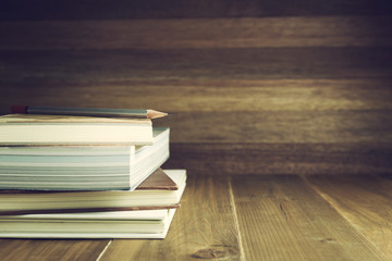 Books and pencil on wood table and background, selective focus