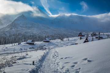 Fototapeta na wymiar Winter mountain trail to a shelter at sunrise, Tatras, Poland