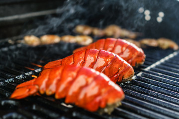 Lobster tails cooking on grill