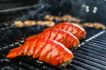 Schilderijen op glas Lobster tails cooking on grill © Joshua Resnick