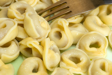 Tortellini are ring-shaped pasta or 