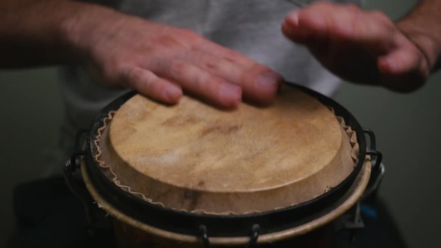 Playing the bongo with two hands.
