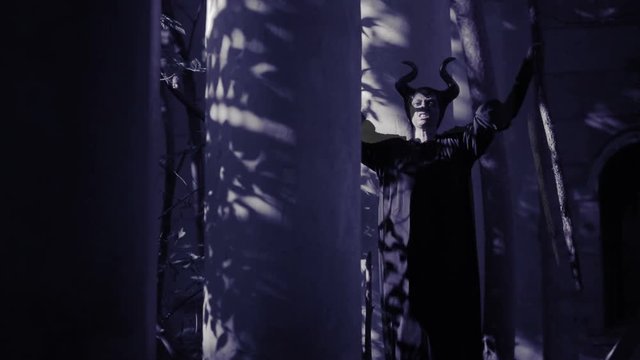 horned witch ghost walks through the ruins of the castle. halloween Horror