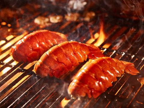 Lobster tails cooking on grill