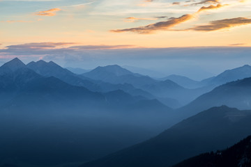 Fototapeta na wymiar Misty mountain landscape in the evening at sunrise