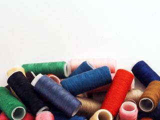 colored spools of thread on white