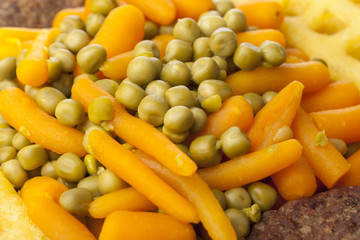 Obraz na płótnie Canvas Peas and carrots with burgers and potato waffles