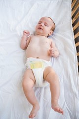 Baby lying on baby bed
