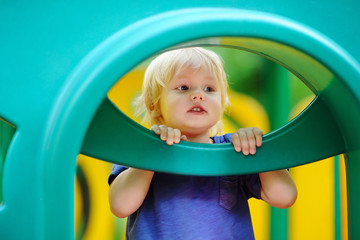 Toddler boy having fun on playground