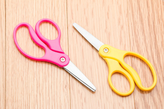 Scissors for children on a school desk.