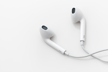 White ear buds on a white background. - 121883570