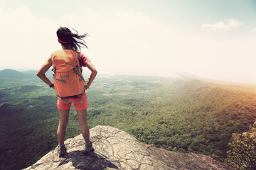 successful woman hiker  enjoy the view at mountain peak