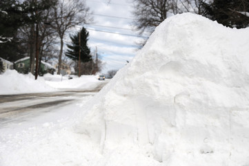 snow pile by the side of street after snow storm