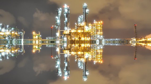 Twilight scene of oil refinery industrial plant with vertical mirror effect 