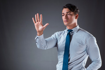 Handsome businessman pressing virtual buttons