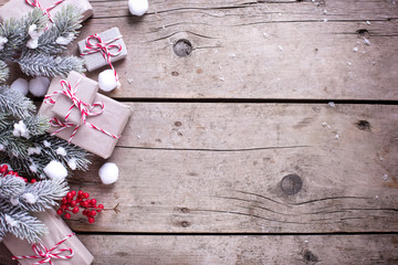 Border from wrapped christmas presents, fur tree branches, red b