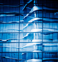 distorted building reflected at glass,blue toned.