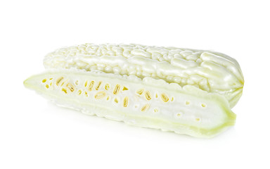 whole and half cut fresh bitter gourd on white background