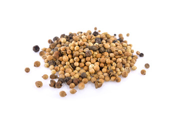 pile of dried coriander seeds on white background
