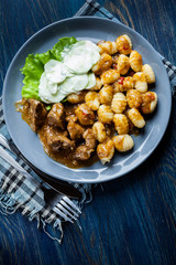 Italian potato dumplings with stew and cucumber salad