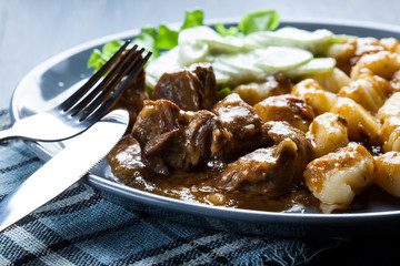 Italian potato dumplings with stew and cucumber salad