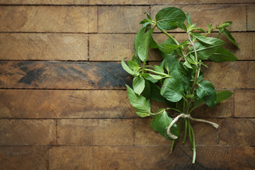 Bunch of fresh mint on wooden background, top view