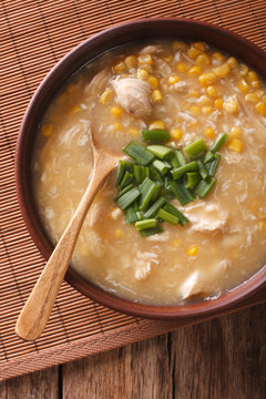 Chinese thick corn soup with chicken close up. vertical top view
