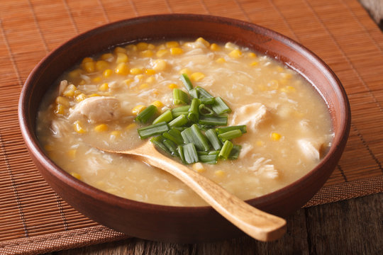 Delicious corn and chicken soup close up in a bowl. horizontal
