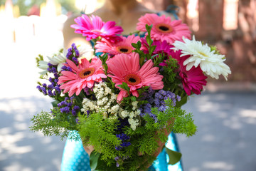 Woman holding bouquet of pink flowers