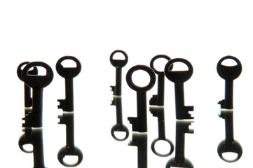 Old rusty keys on white background. Mirror
